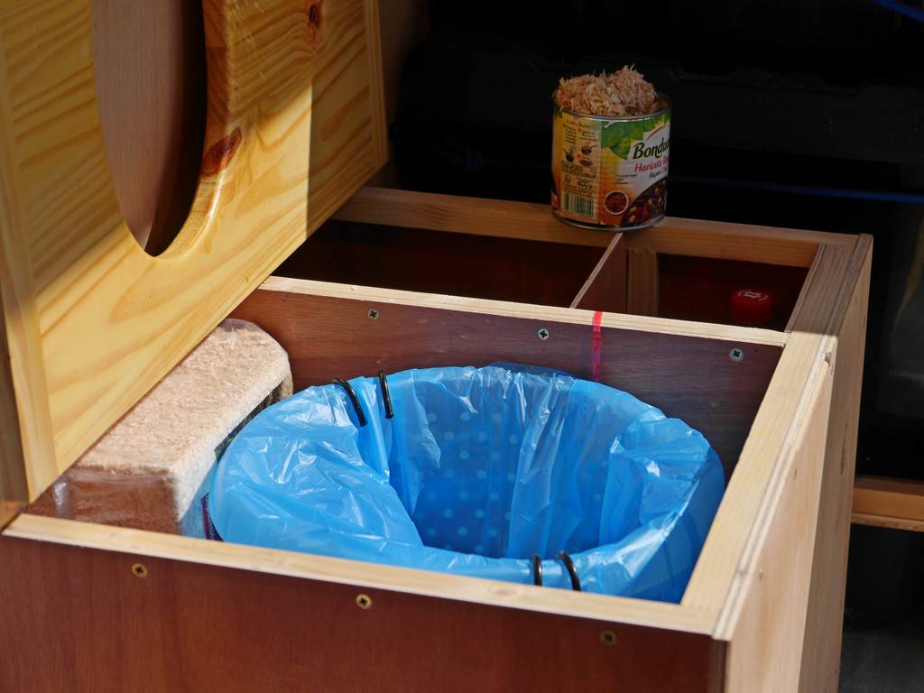 open toilet drawer with my wood chips tin can